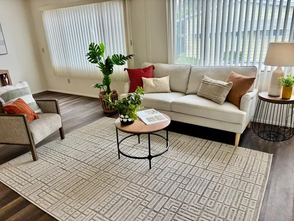 a living room with furniture and a potted plant