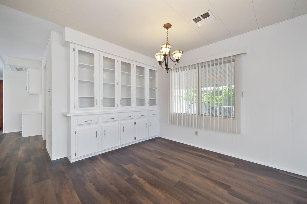 163 Rimma Way Roseville, CA 95661 - Photo 8 of 35 a view of an empty room with wooden floor and a window