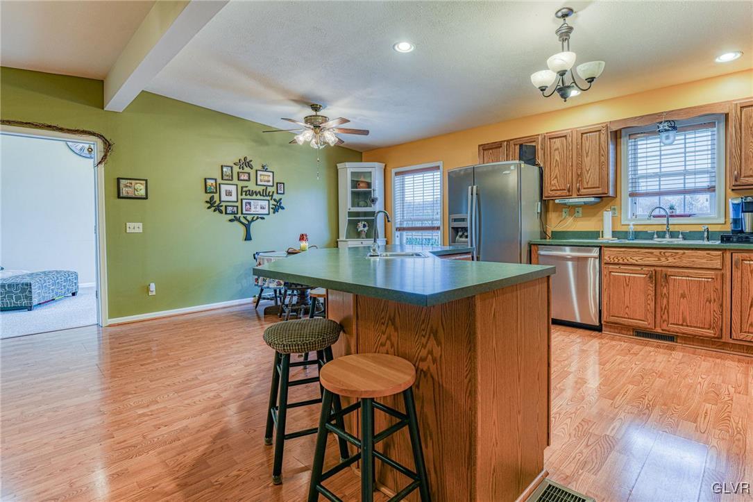 542 Bauer Road Bath, PA 18014 - Photo 12 of 31 a kitchen with stainless steel appliances granite countertop wooden cabinets a dining table and chairs