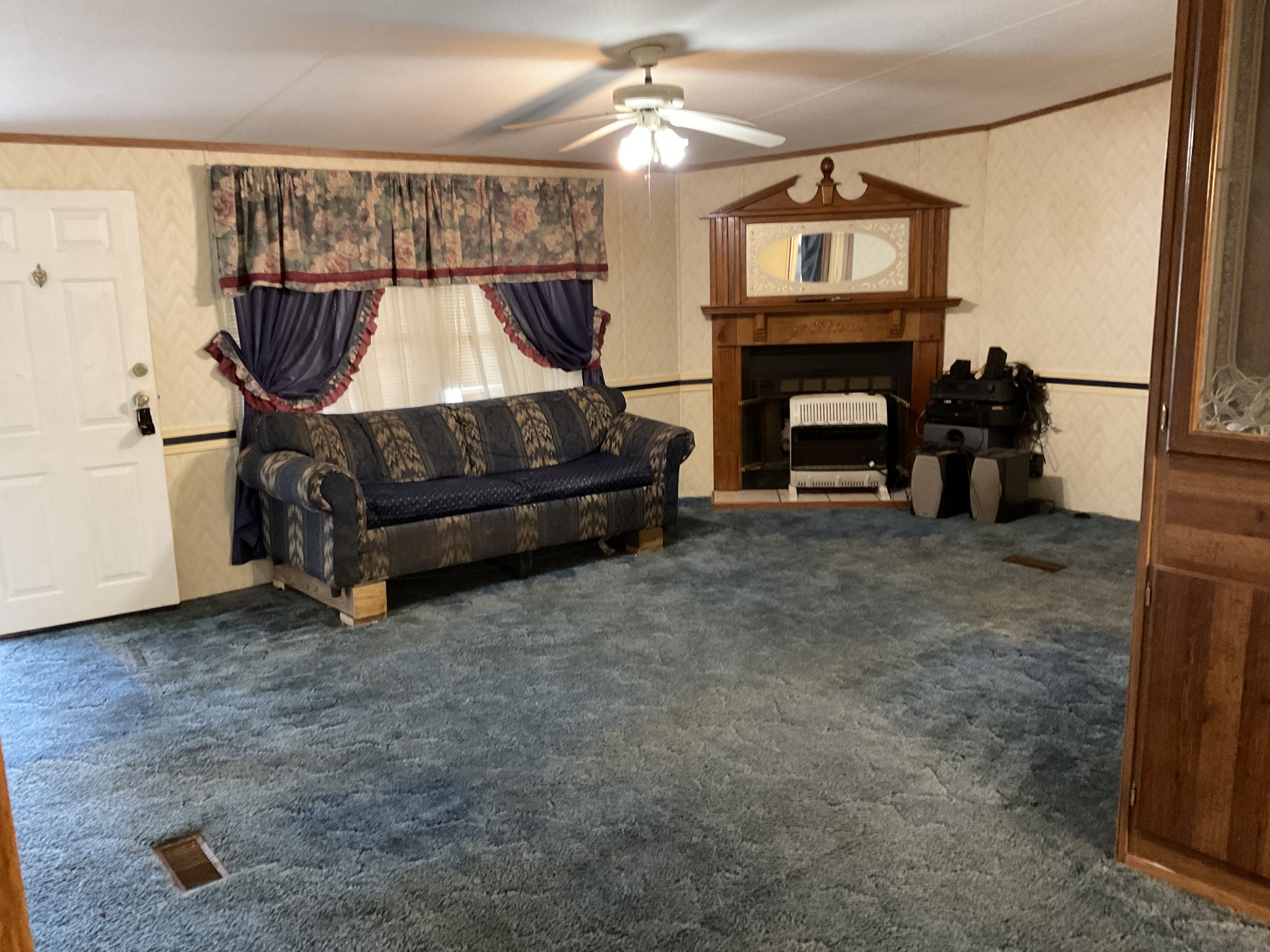 167 Dripping Springs Street Crofton, KY 42217 - Photo 2 of 30 a living room with furniture a fireplace and a flat screen tv