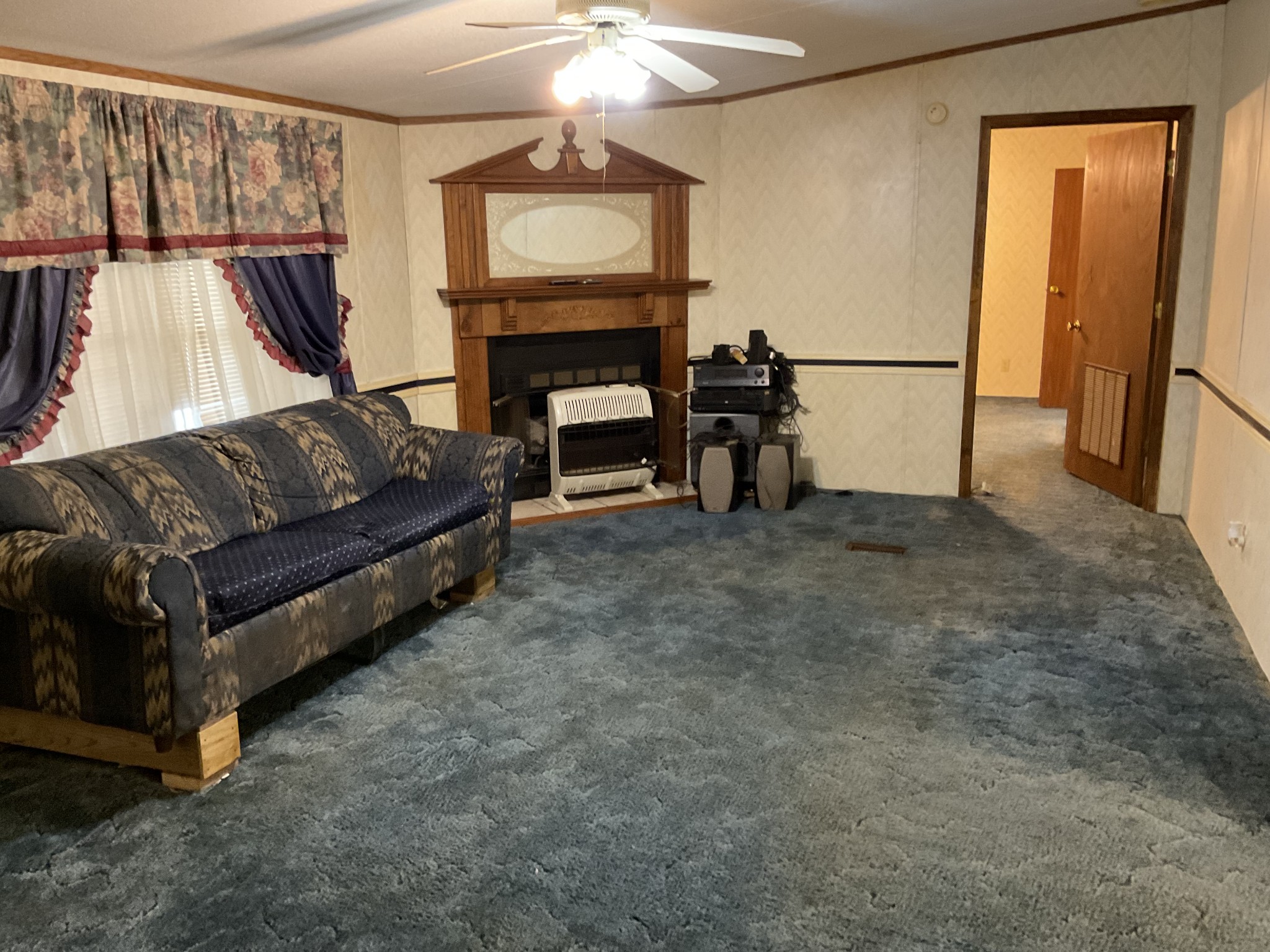 167 Dripping Springs Street Crofton, KY 42217 - Photo 3 of 30 a living room with furniture a fireplace and a flat screen tv