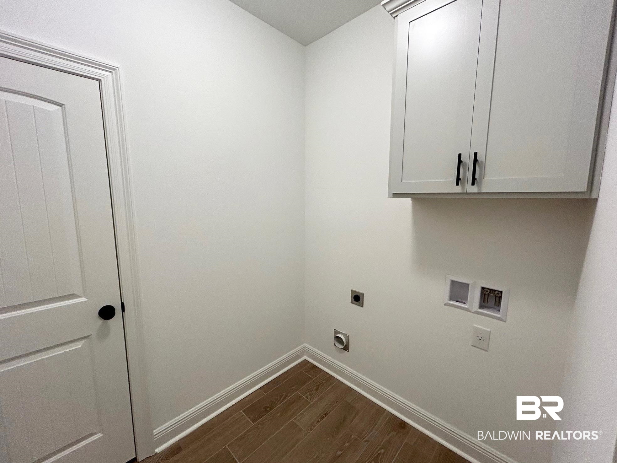 812 Sumter Loop Foley, AL 36535 - Photo 14 of 17 Clothes washing area featuring cabinets, hookup for a washing machine, dark hardwood / wood-style flooring, and electric dryer hookup