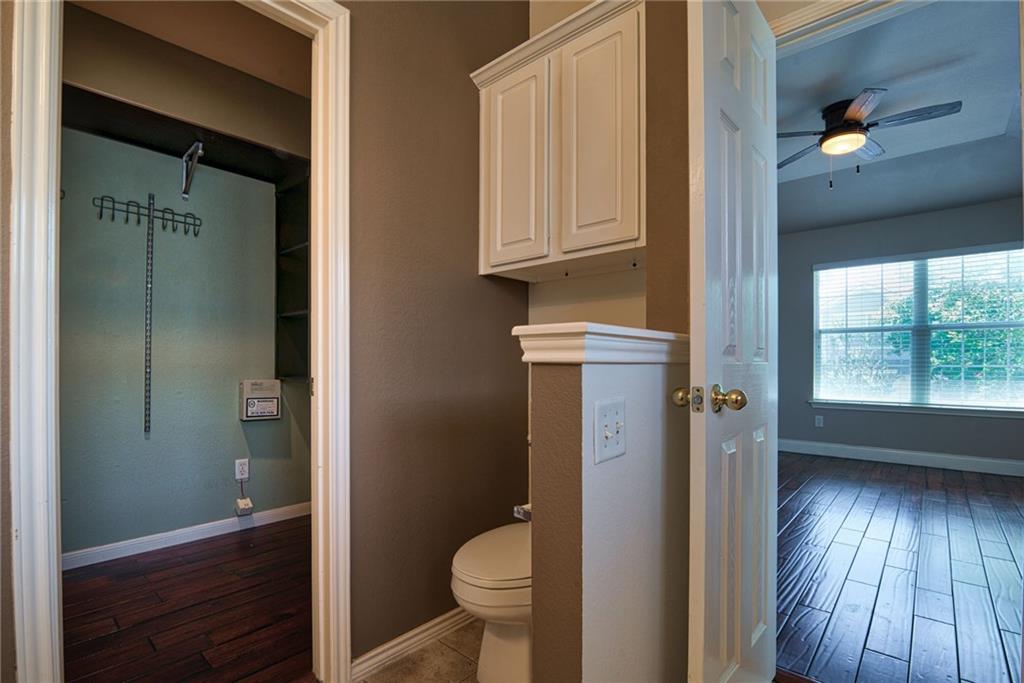 1900 Scofield Ridge Parkway, Unit 5501 Austin, TX 78727 - Photo 13 of 21 A well-appointed closet offers abundant storage, seamlessly connecting to a private toilet area.