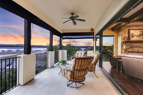 a view of a porch with furniture and backyard