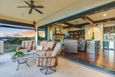 a living room with patio furniture and a floor to ceiling window