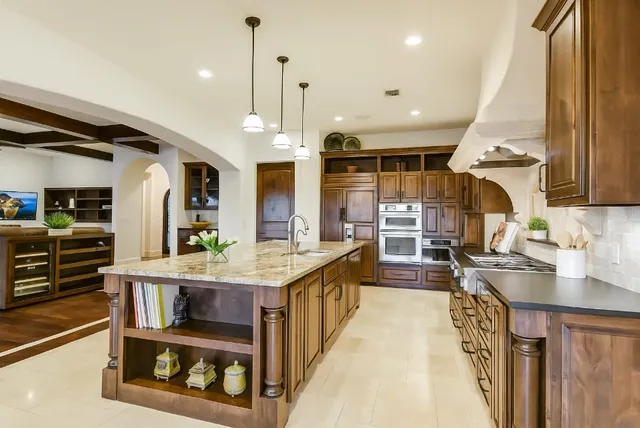 a kitchen with stainless steel appliances granite countertop a stove and a sink