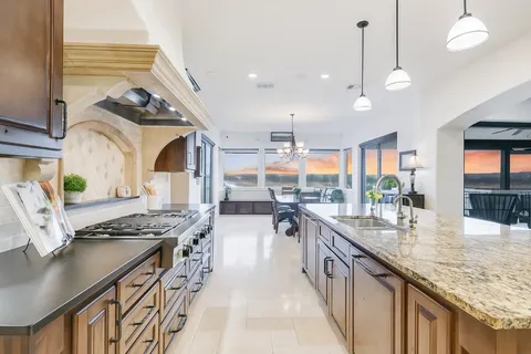 a kitchen with stainless steel appliances granite countertop a sink and cabinets