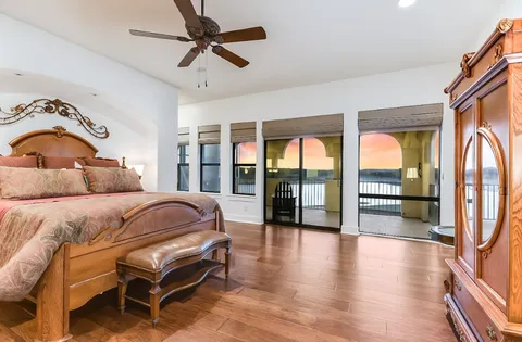 a spacious bathroom with a granite countertop sink a mirror and a bathtub