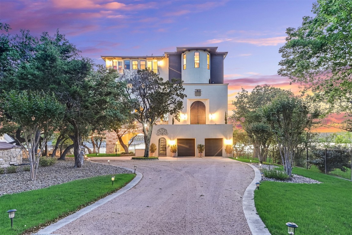 17017 South Ridge Lane Austin, TX 78734 - Photo 26 of 28 a front view of a house with a yard and a garden