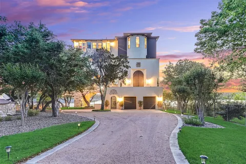 a front view of a house with a yard and a garden