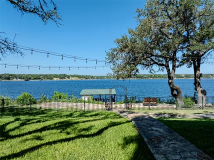 a view of a swimming pool with a yard