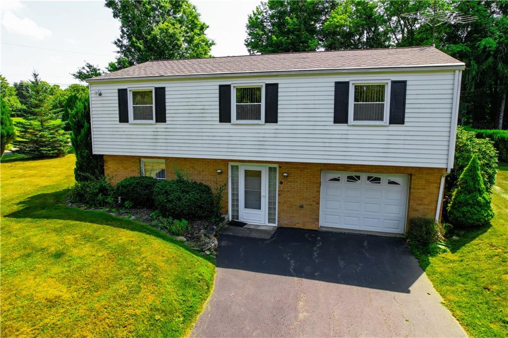 130 Country Club Road Butler, PA 16002 - Photo 1 of 38 a front view of a house with garden