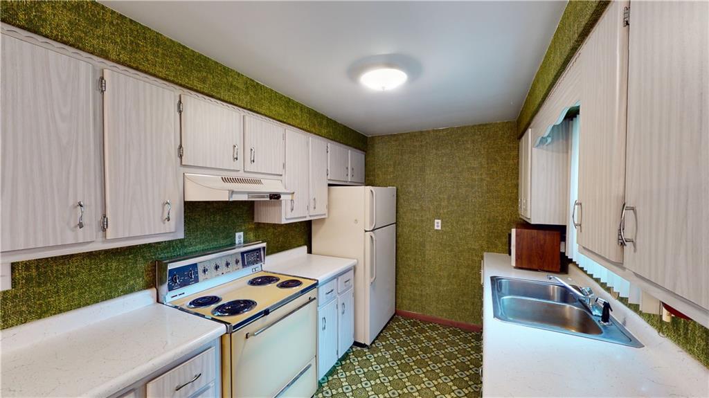 130 Country Club Road Butler, PA 16002 - Photo 12 of 38 a kitchen with a stove a refrigerator and a sink