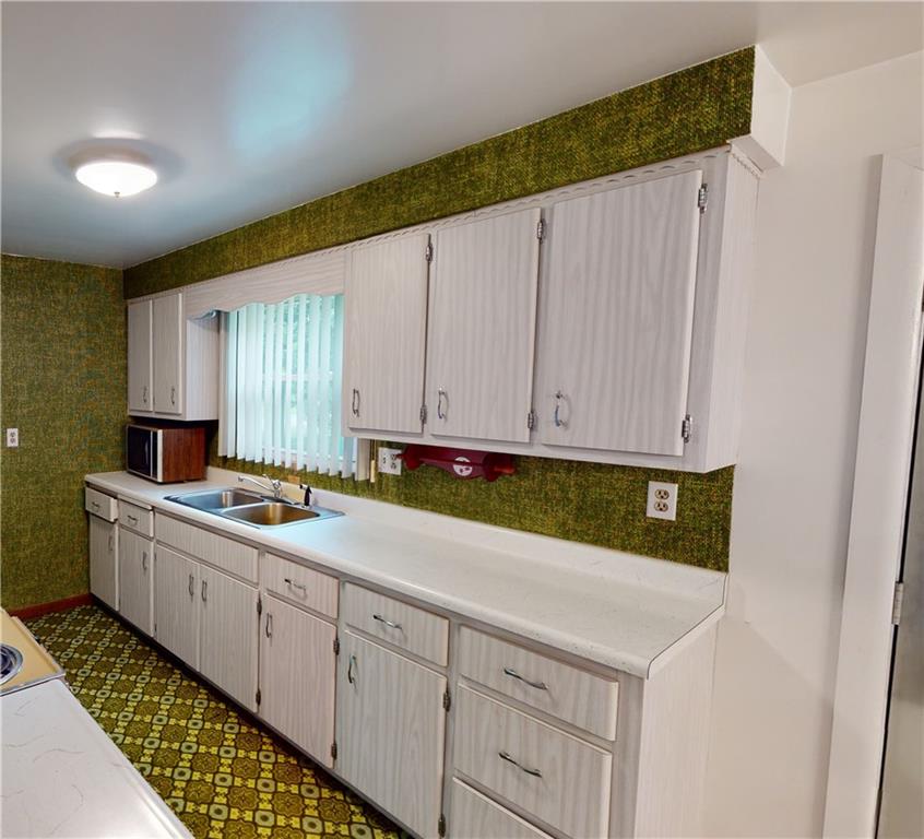 130 Country Club Road Butler, PA 16002 - Photo 13 of 38 a kitchen with a sink and cabinets
