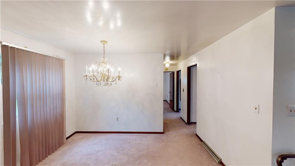 130 Country Club Road Butler, PA 16002 - Photo 10 of 38 an empty room with chandelier and windows