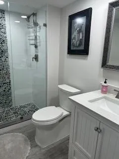 a bathroom with a toilet sink and shower