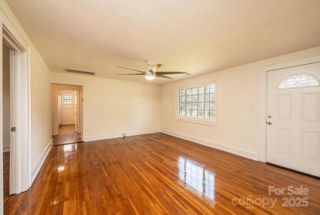 1993 Moss Farm Road Hickory, NC 28602 - Photo 14 of 41 a view of an empty room with wooden floor and a window