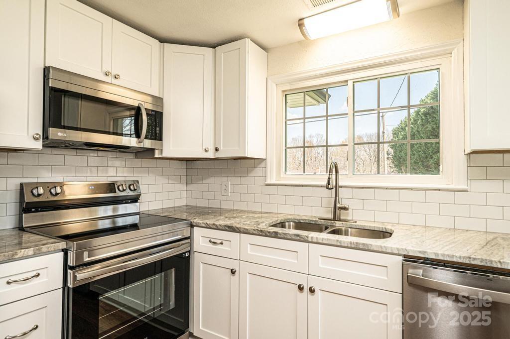 1993 Moss Farm Road Hickory, NC 28602 - Photo 18 of 41 a kitchen with stainless steel appliances granite countertop white cabinets granite counter tops and a window