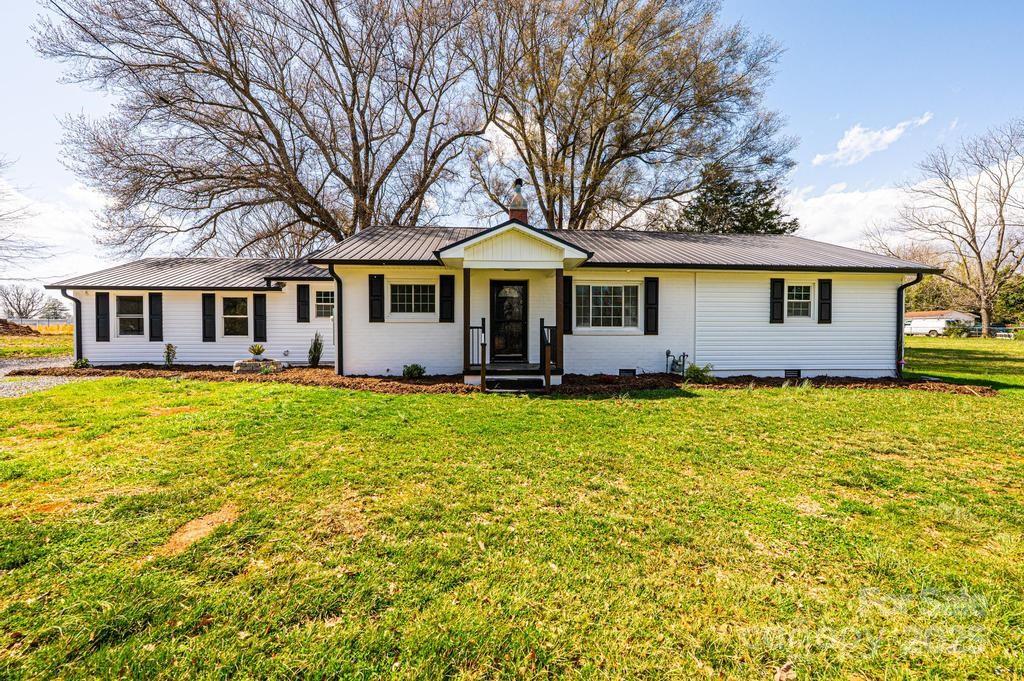 1993 Moss Farm Road Hickory, NC 28602 - Photo 2 of 41 a front view of house with yard and trees around