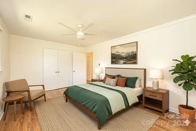 a bedroom with a bed and a potted plant