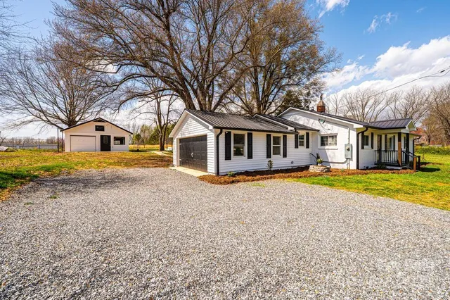 a house with swimming pool in front of it