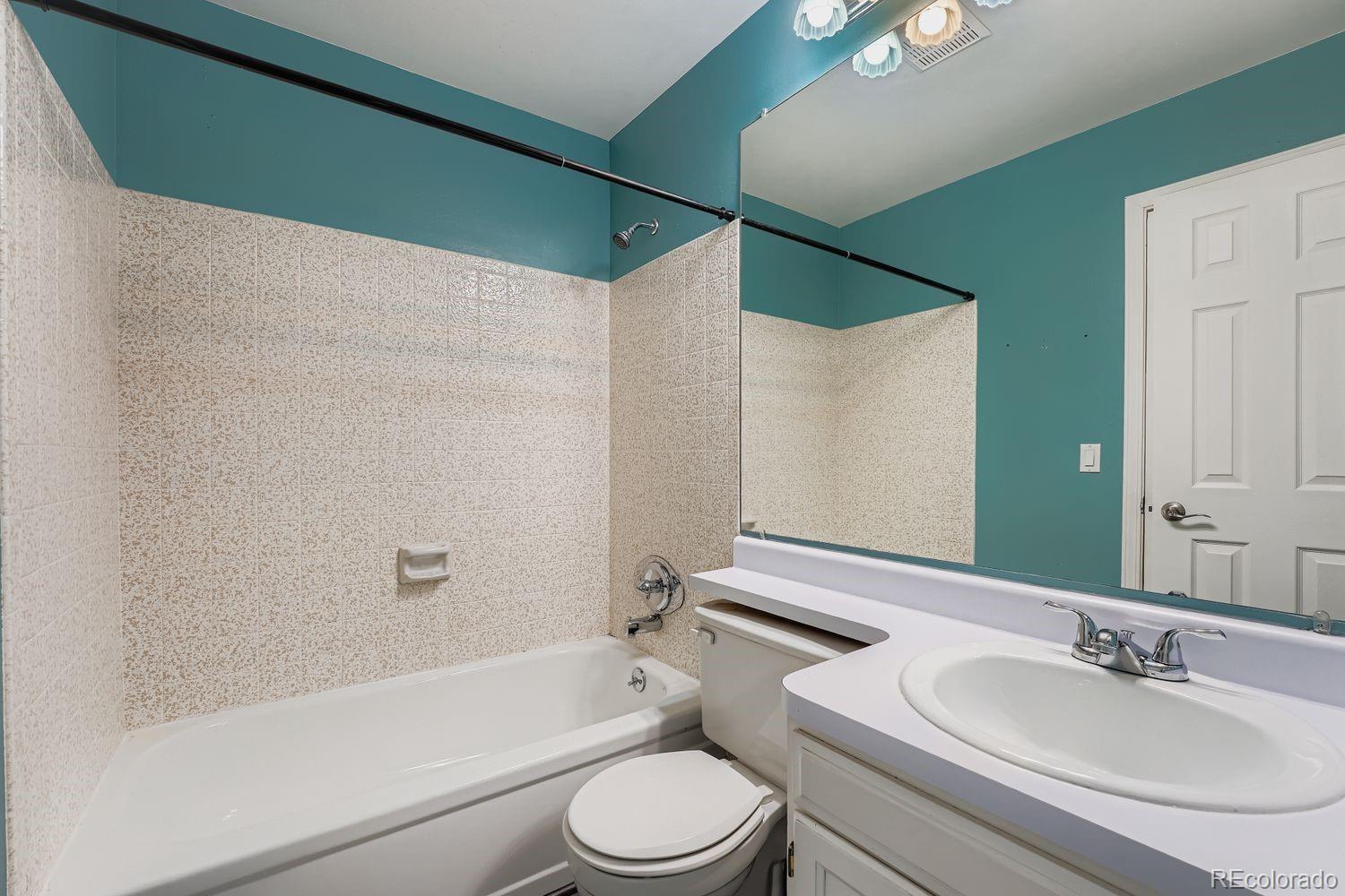 2204 South Jasper Way, Unit B Aurora, CO 80013 - Photo 11 of 19 a bathroom with a sink toilet and shower