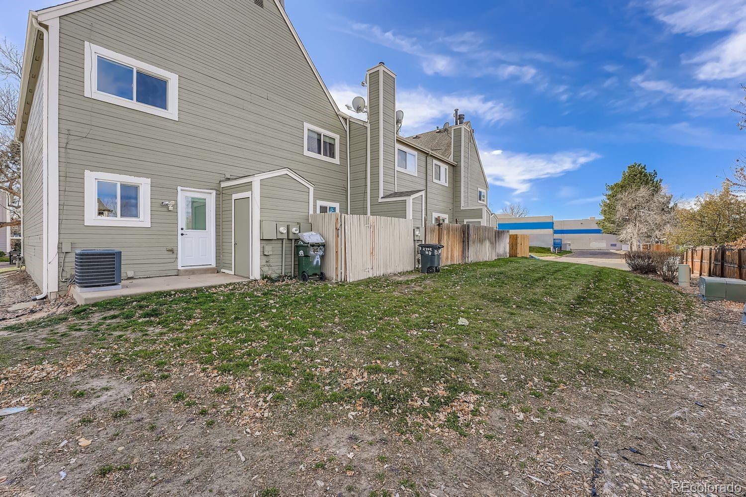 2204 South Jasper Way, Unit B Aurora, CO 80013 - Photo 16 of 19 a front view of a house with a yard