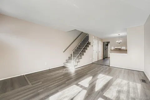 a view of an empty room and wooden floor
