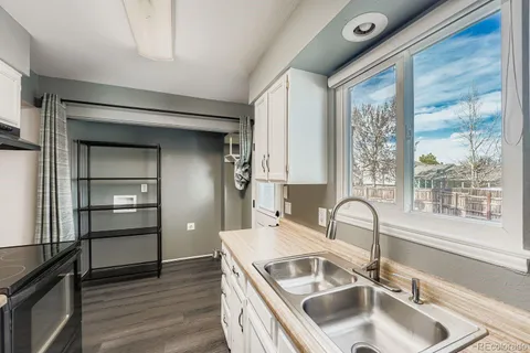 a kitchen with a sink and a refrigerator