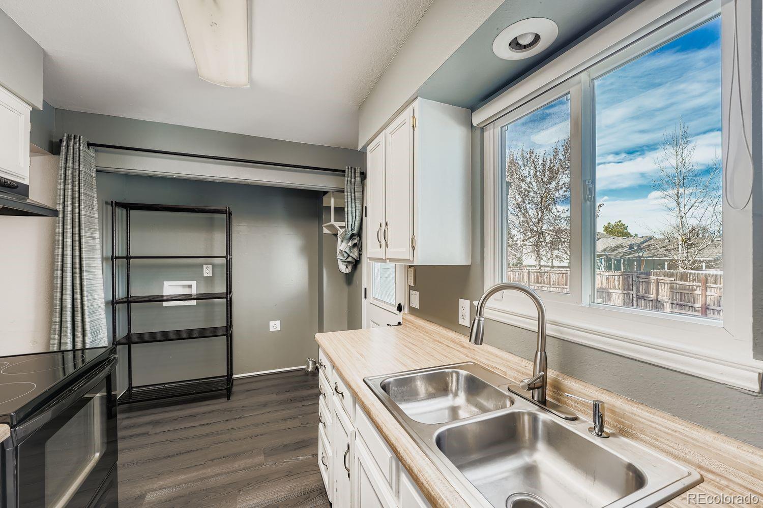 2204 South Jasper Way, Unit B Aurora, CO 80013 - Photo 6 of 19 a kitchen with a sink and a refrigerator