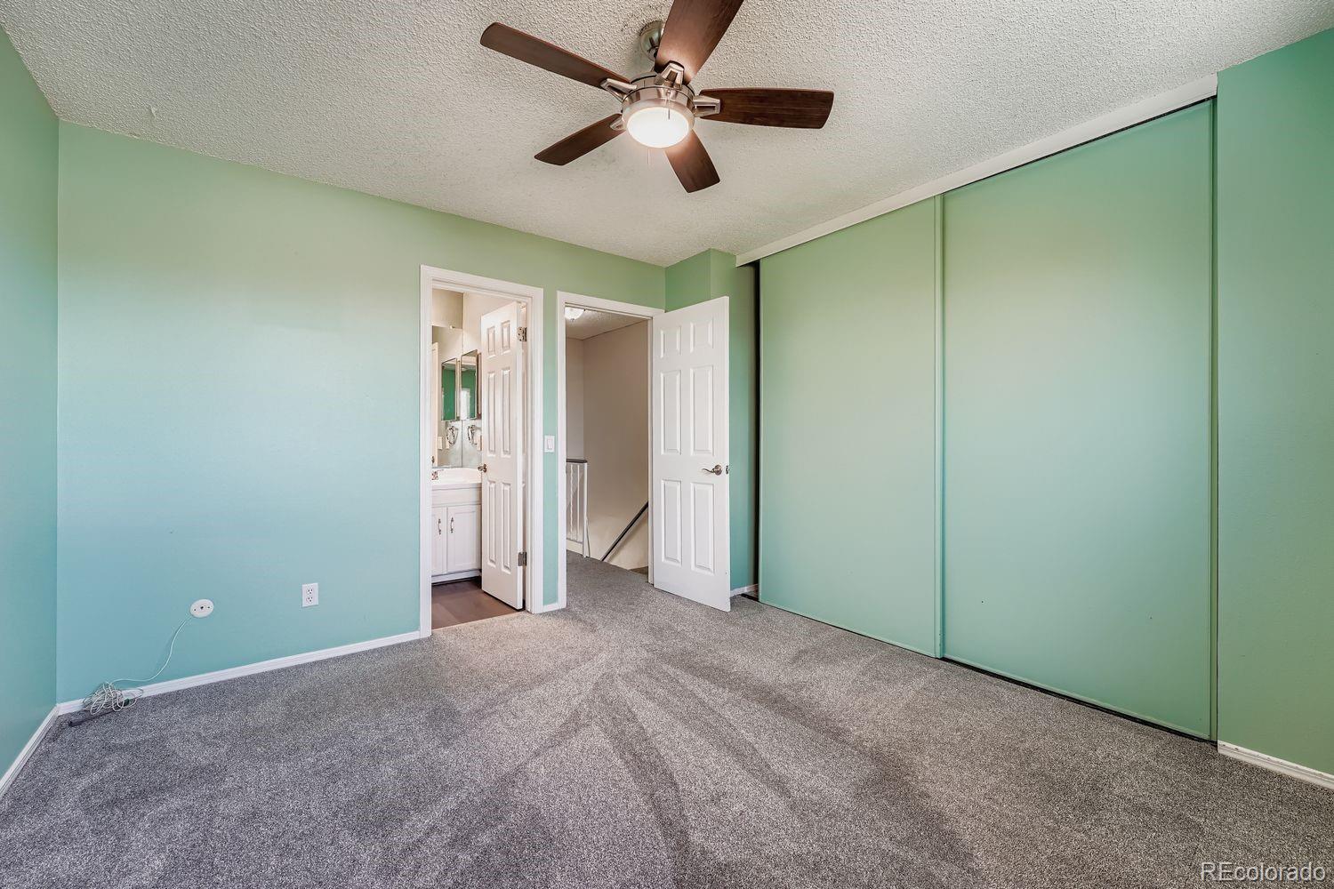 2204 South Jasper Way, Unit B Aurora, CO 80013 - Photo 9 of 19 a view of a room with a ceiling fan and a hardwood