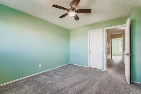 an empty room and chandelier fan