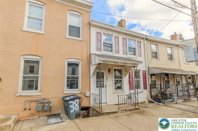 a front view of a brick building with many windows