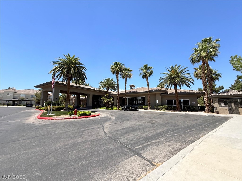 9050 West Warm Springs Road, Unit 2002 Las Vegas, NV 89148 - Photo 37 of 46 This inviting entrance features lush landscaping, ample parking, and an impressive architectural facade.