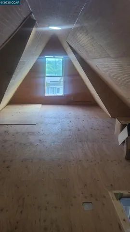 a kitchen with a stove and a wooden door