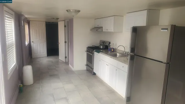 a bathroom with a granite countertop toilet and a sink