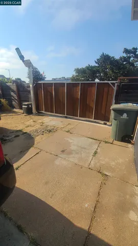 a view of a yard with wooden fence