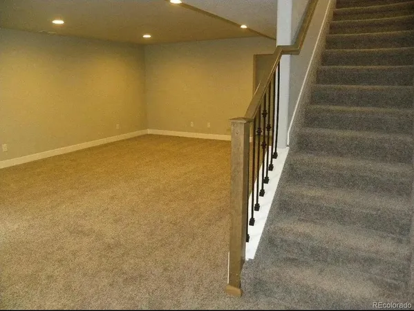wooden floor in an empty room with stairs