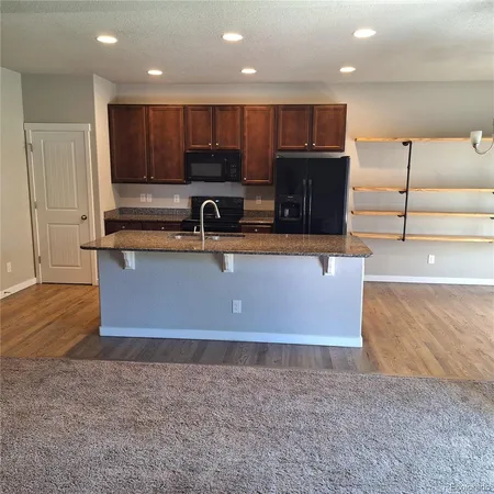 a view of kitchen with stainless steel appliances cabinets