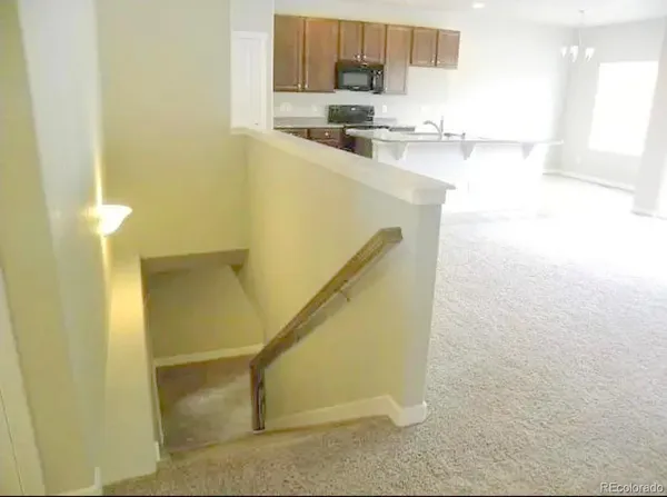 a kitchen with kitchen island a sink a counter top space and cabinets