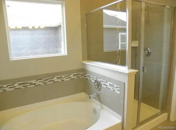 a bath tub sitting next to a window