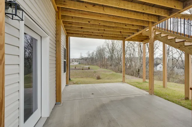 a view of a house with porch and a yard