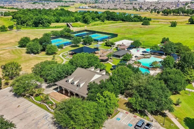 an aerial view of a houses with outdoor space swimming pool and green space