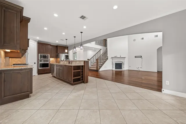 a kitchen with stainless steel appliances a stove a sink and a refrigerator