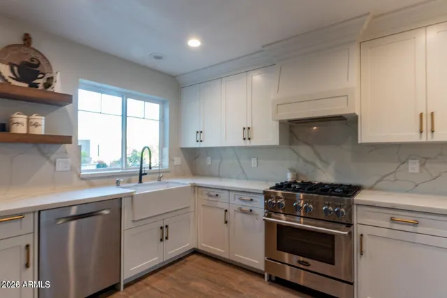 a kitchen with a table chairs wooden floors and appliances