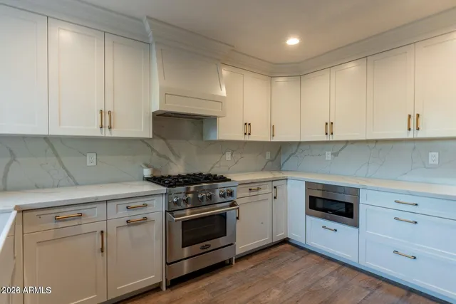 a kitchen with cabinets appliances and a window