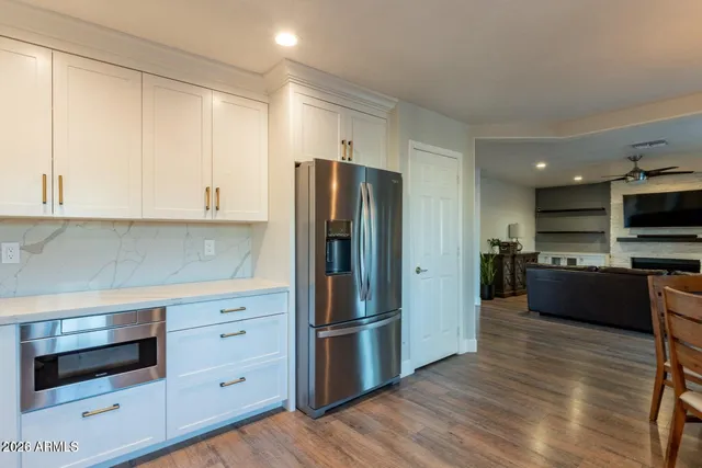 a kitchen with white cabinets and white appliances