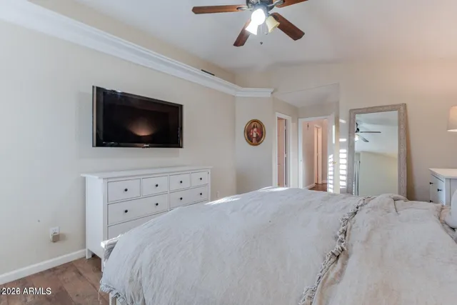 a bedroom with a bed and wooden floor