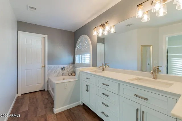 a spacious bathroom with a mirror a sink and a large mirror