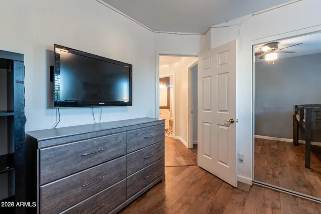 a bedroom with a bed and a ceiling fan